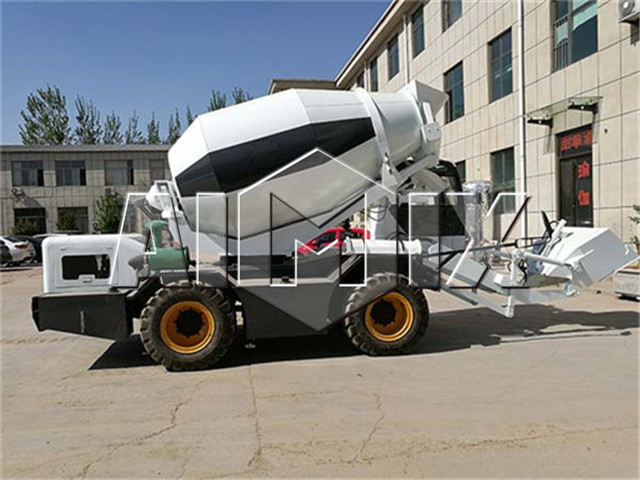 Self loading concrete mixer